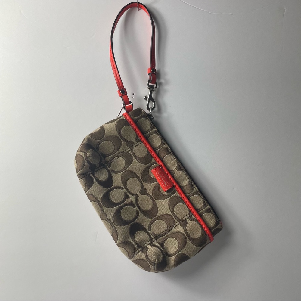 Tan coach purse with orange handle and interior